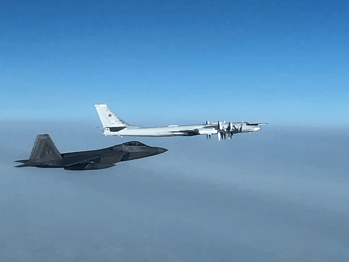 An F-22 intercepts a Russian Tu-95 “Bear” bomber in international airspace near Alaska.